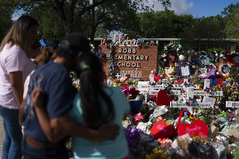 People visit a memorial at Robb Elementary School in Uvalde, Texas, on Thursday, June 2, 2022, to pay their respects to the victims killed in last week's school shooting. (AP/Jae C. Hong)