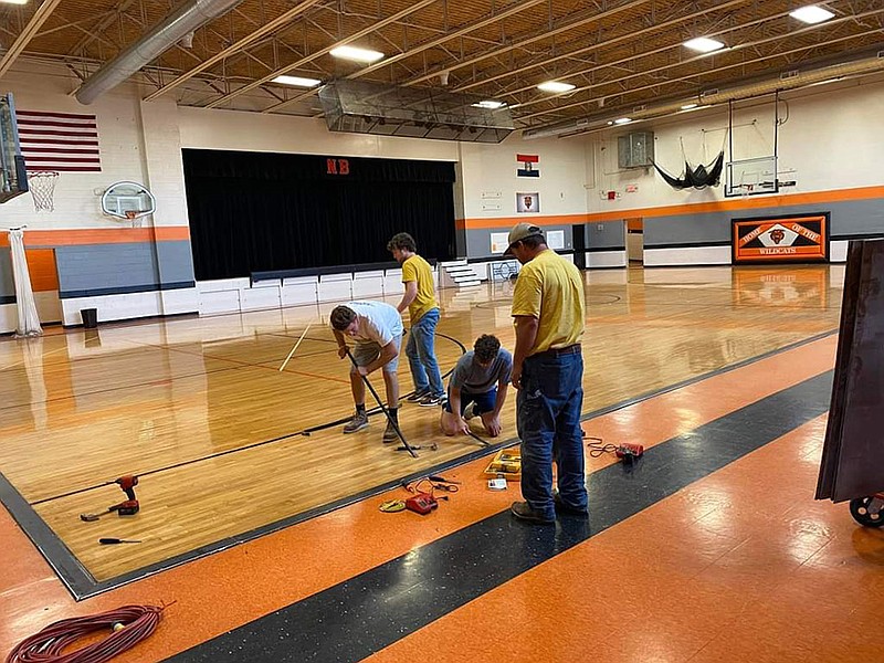 A crew works on the New Bloomfield Elementary School gym floor during the first step of replacing it. (Submitted)