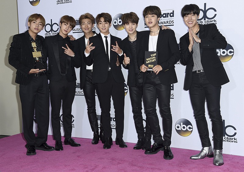 BTS, a South Korean band, poses in the press room with the award for top social artist at the Billboard Music Awards at the T-Mobile Arena on Sunday, May 21, 2017, in Las Vegas. (Photo by Richard Shotwell/Invision/AP)