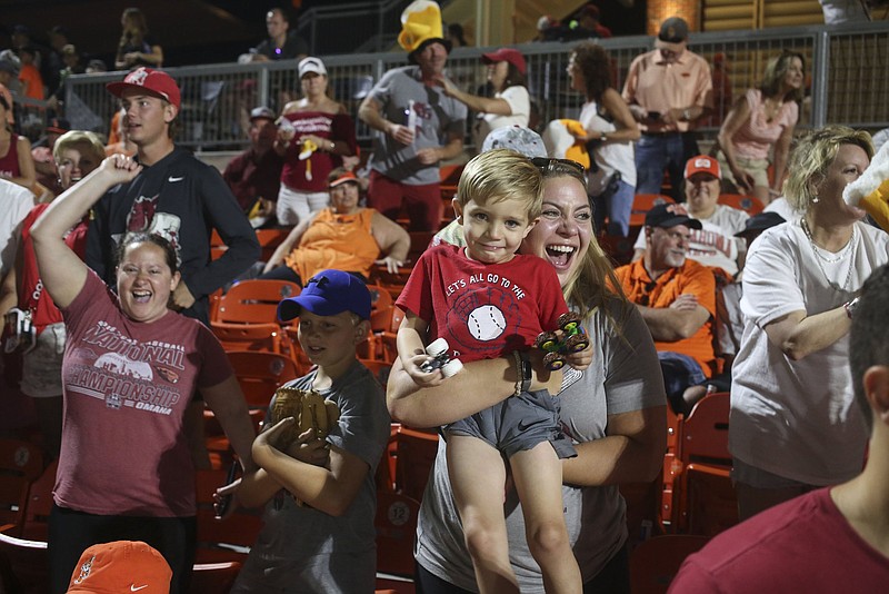 Arkansas fans celebrate on Saturday following the Razorbacks’ 20-12 victory over Oklahoma State in the NCAA Stillwater (Okla.) Regional. Arkansas advanced to today’s regional championship game, where they will face either Missouri State or Oklahoma State for a chance to advance to the super regionals.
(NWA Democrat-Gazette/Charlie Kaijo)