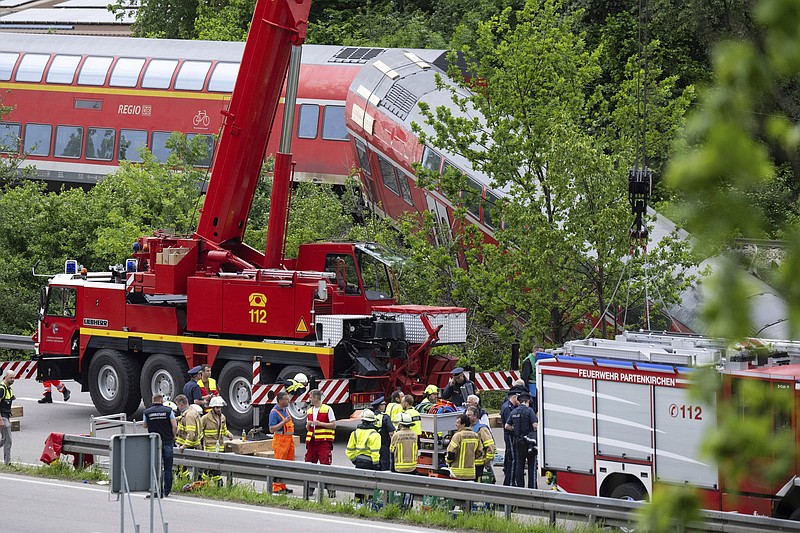 Emergency and rescue forces work on the site of a train crash Friday in Burgrain, Germany.
(AP/Sven Hoppe)