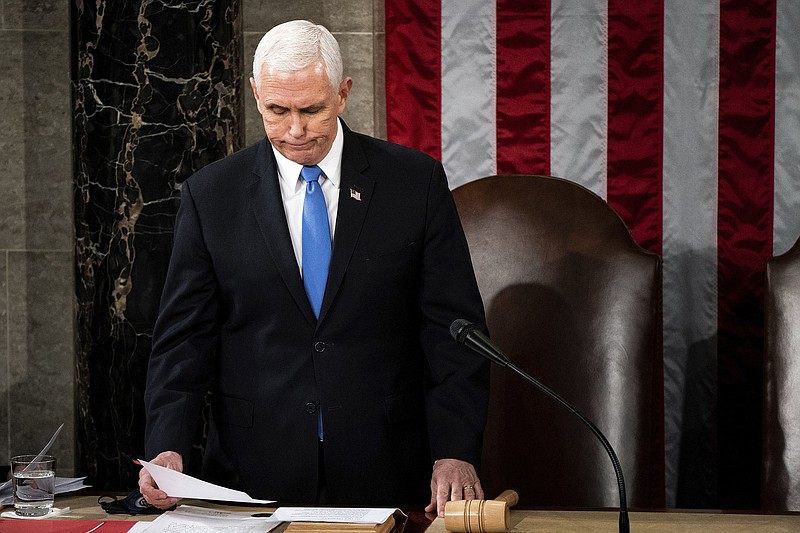Vice President Mike Pence officiates at a joint session of the House and Senate convenes Jan. 6, 2021, to confirm the Electoral College votes. Facing pressure from then-President Donald Trump to reject the results and a warning about his security, Pence refused to try to overturn the results.
(AP/The New York Times/Erin Schaff)
