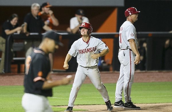Arkansas' Robert Moore celebrates as he scores a run during an NCAA Tournament game against Oklahoma State on Saturday, June 4, 2022, in Stillwater, Okla.