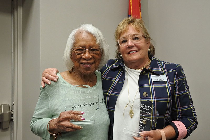 Retired Fort Smith School Board members Yvonne Keaton-Martin, left, and Susan McFerran, right, stand side-by-side with the awards they received in honor of their service after the Fort Smith School Board meeting Monday. .(NWA Democrat-Gazette/Thomas Saccente)