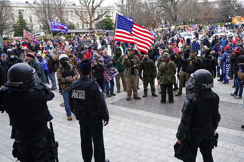 U.S. Capitol Police officers stand outside a door on the Senate side of the U.S. Capitol as rioters storm the capitol on Jan. 6, 2021, in Washington. (AP/Manuel Balce Ceneta)