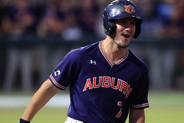 Auburn infielder Cole Foster (7) runs to first after hitting a home run during an NCAA baseball game on Friday, June 3, 2022 in Auburn, Ala. (AP Photo/Butch Dill)