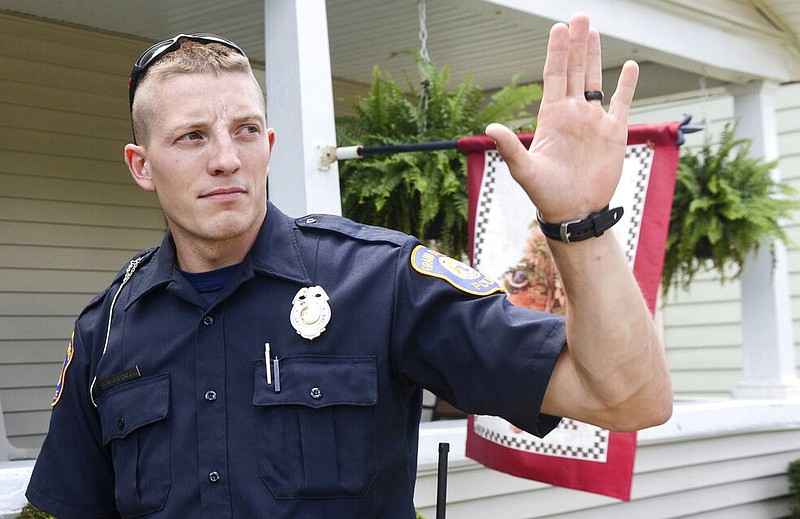 Grand Rapids (Mich.) Police Officer Christopher Schurr stops to talk with a resident of Grand Rapids in this Aug. 12, 2015 file photo. A prosecutor filed a second-degree murder charge Thursday, June 9, 2022 against Schurr, the Michigan police officer who killed Patrick Lyoya, a Black man who was on the ground when he was shot in the back of the head after an intense physical struggle recorded on a bystander's video. (Emily Rose Bennett/The Grand Rapids Press via AP, File)