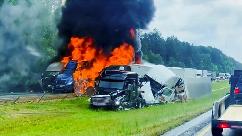 In this image taken from video flames and smoke billow from trucks involved in a deadly multiple vehicle crash along Interstate 30 in southwestern Arkansas, Wednesday, June 8, 2022. (AP/Joni Deardorff)