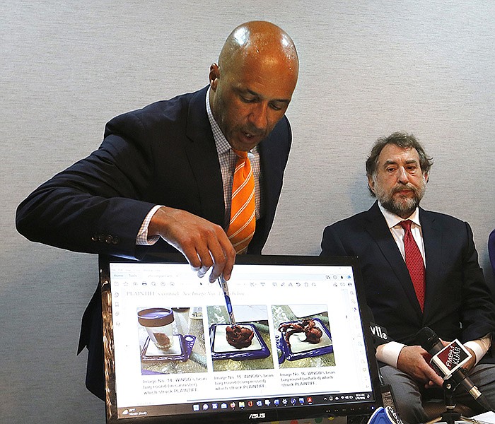 Attorney Mike Laux (left) describes Friday the beanbag rounds with which his client, Don Cook (right), was shot in the face with during protests on June 1, 2020, outside the state Capitol. Laux announced a federal lawsuit against the Arkansas State Police that was filed on Friday.
(Arkansas Democrat-Gazette/Thomas Metthe)