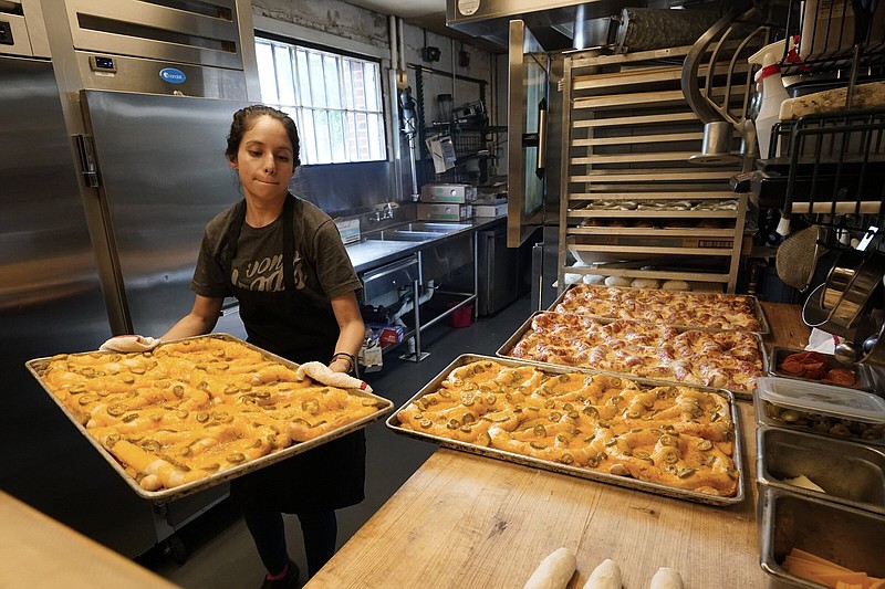 Sandra Castillo removes pretzels from the oven at Von Elrod’s Beer Hall & Kitchen on Tuesday, in Nashville, Tenn. Inflation and the worker shortage have sent the restaurant’s costs skyrocketing.
(AP/Mark Humphrey)