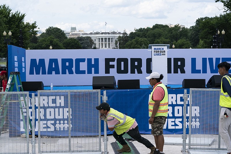 Workers set up for the March for Our Lives rally on the National Mall on Friday in Washington. The march is returning to Washington after four years.
(AP/Alex Brandon)