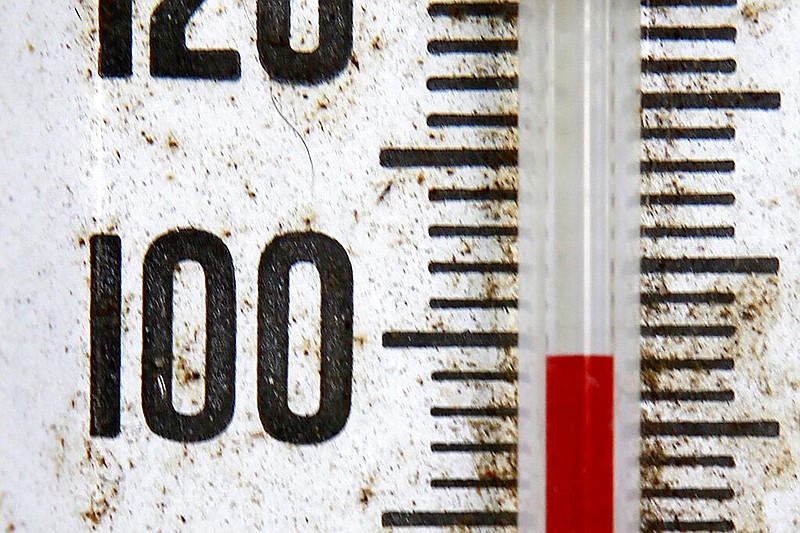 An outdoors thermometer records temperatures of just below 100 degrees in this July 29, 2009 file photo. (AP/Elaine Thompson)