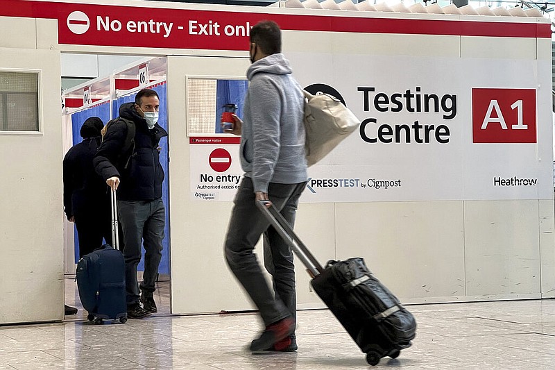 FILE - Passengers get a covid-19 test at Heathrow Airport in London, Nov. 29, 2021. (AP/Frank Augstein, File)