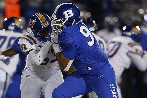 Bryant linebacker TJ Lindsey (99) sheds the block of North Little Rock offensive lineman Desean Williams (57) during the fourth quarter of the North Little Rock's 24-12 loss on Friday, Oct. 29, 2021, at Hornet Stadium in Bryant.