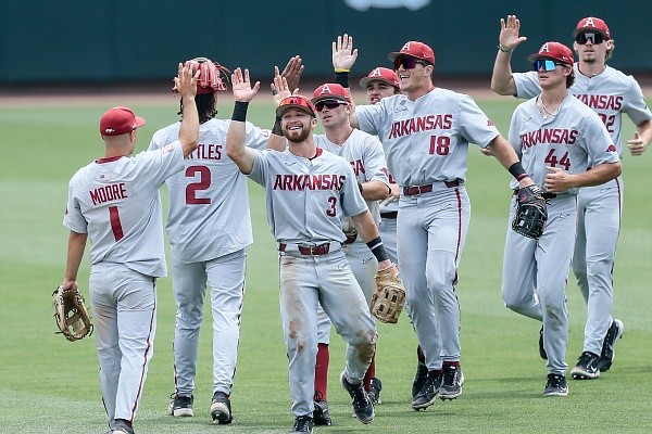 Arkansas players high five on Saturday, June 11, 2022, after the ninth inning of the NCAA Baseball Super Regional opening game at Boshamer Stadium in Chapel Hill, NC. Check out nwaonline.com/220612Daily/ and nwadg.com/photos for the photo gallery.