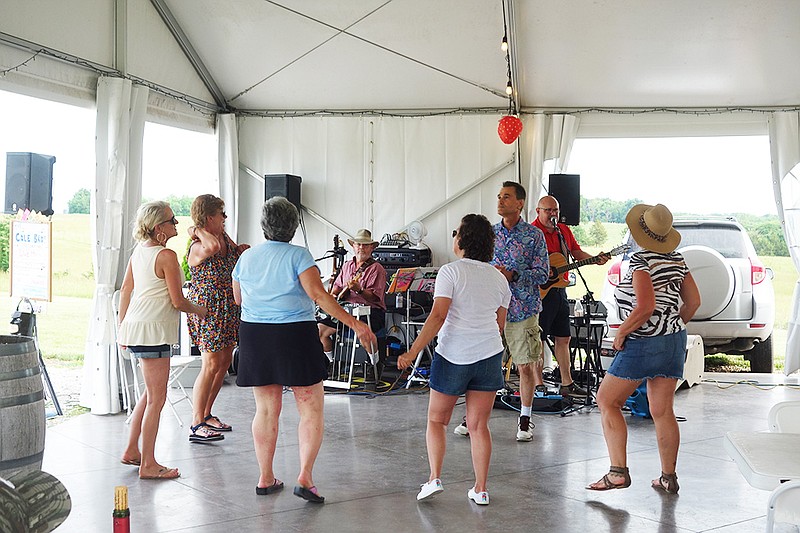 Attendees dance Saturday evening at the MidMo Strawberry Festival at Serenity Winery. (Michael Shine/FULTON SUN)