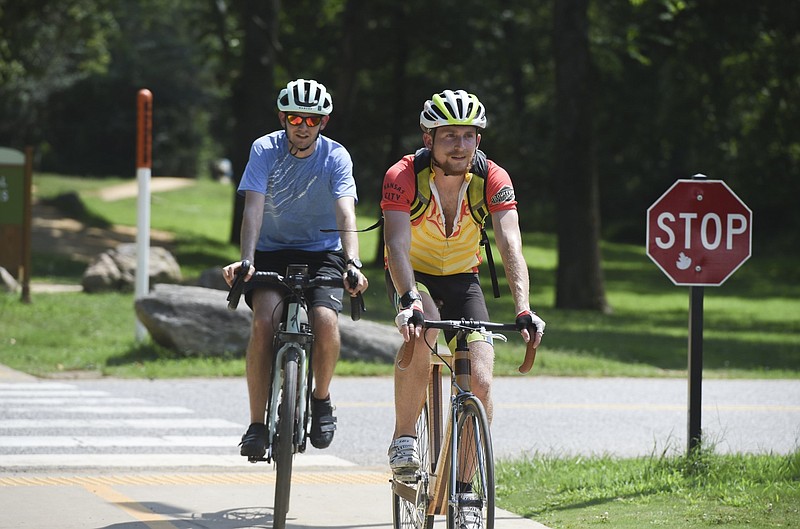 Two bicyclists ride along the Greenway at the North Bentonville Trail in Bentonville in this July 30, 2021 file photo. (NWA Democrat-Gazette/Charlie Kaijo)