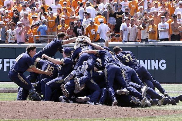 Notre Dame players celebrate after defeating Tennessee in an NCAA college baseball super regional game, Sunday, June 12, 2022, in Knoxville, Tenn. (AP Photo/Randy Sartin)