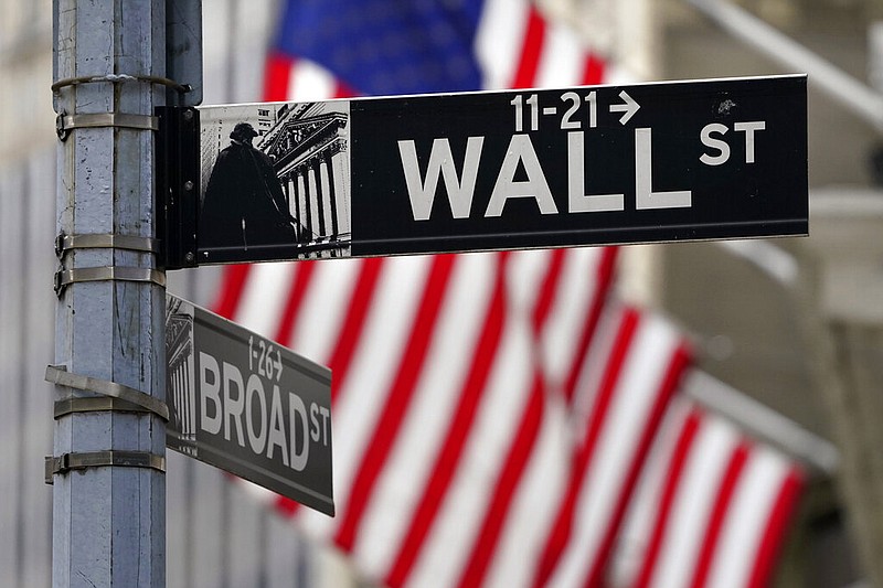 FILE- In this Nov. 23, 2020, file photo, a Wall Street sign is displayed outside of the New York Stock Exchange in New York. (AP/Seth Wenig, File)