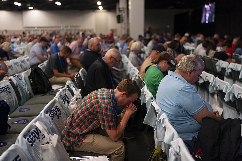 Attendees pray during a worship service at the Southern Baptist Convention's annual meeting in Anaheim, Calif., Tuesday, June 14, 2022. (AP Photo/Jae C. Hong)