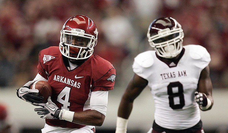 Arkansas’ Jarius Wright heads to the end zone for a touchdown after making a catch over Texas A&M’s Garrick Williams on Oct. 1, 2011, at Cowboy Stadium in Arlington, Texas. 
(Democrat-Gazette file photo/William Moore)