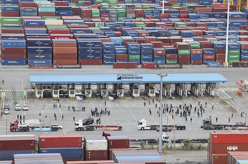 Members of the Cargo Truckers Solidarity of the Korean Confederation of Trade Unions gather in front of a shipping port in Gwangyang, South Korea, on Tuesday. A weeklong strike by thousands of truckers in South Korea has triggered major disruptions in cargo transport and production.
(AP/Kim Dong-ju)