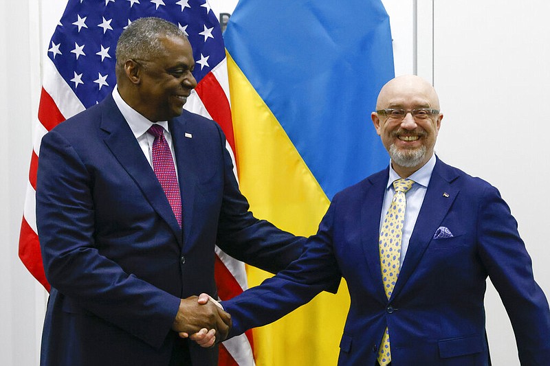 U.S. Defense Secretary Lloyd Austin, left, shakes hands with Ukraine's Defense Minister Oleksii Reznikov ahead of a NATO defence ministers' meeting at NATO headquarters in Brussels, Wednesday, June 15, 2022. (Yves Herman, Pool Photo via AP)