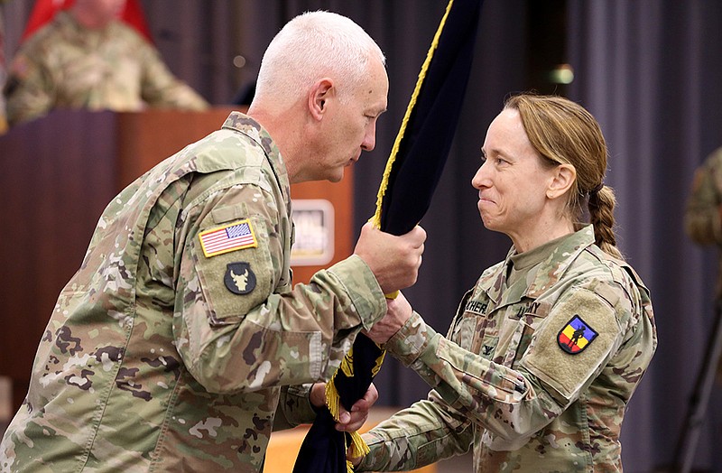 Army National Guard director Lt. Gen. Jon A. Jensen (left), passes the unit guidon to Col. Catherine Cherry (right) as she assumes command of the Army National Guard Bureau’s Lavern E. Weber Professional Education Center during a change of command ceremony on Thursday at Camp Robinson in North Little Rock. Cherry is the first female commander of the PEC.
(Arkansas Democrat-Gazette/Thomas Metthe)
