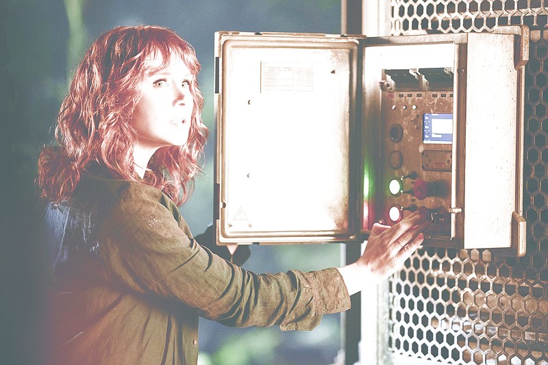 Claire Dearing (Bryce Dallas Howard) fiddles with a power box in “Jurassic World Dominion,” which came in at No. 1 with $143 million in receipts.