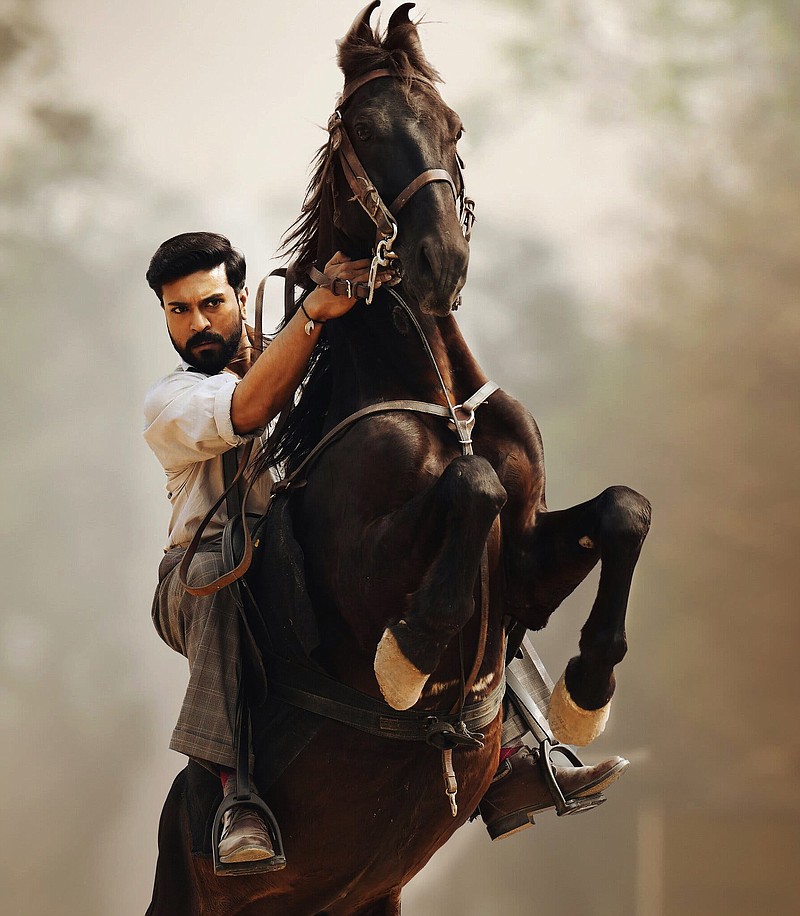 Historically, Alluri Sitarama Raju (Ram Charan) was an Indian revolutionary who waged an armed campaign against British colonial rule in India. In the Bollywood blockbuster “RRR,” he’s an all-singing/all-dancing superhero.