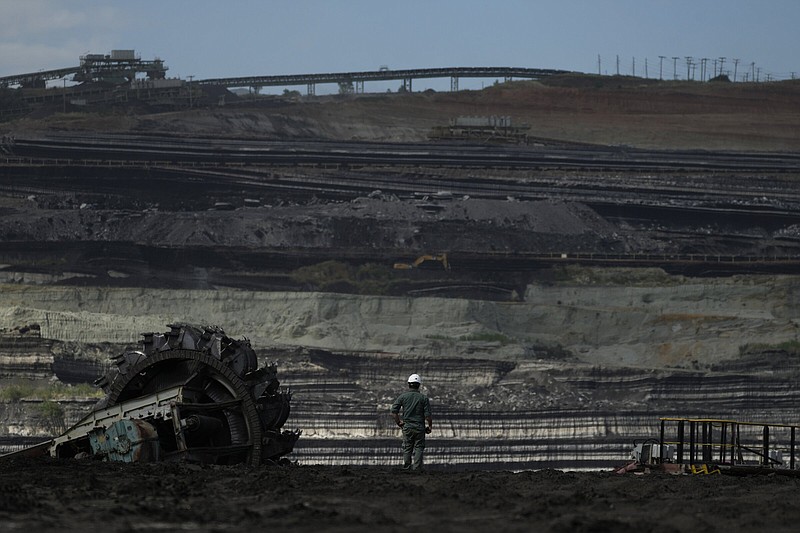 Giorgos Papadopoulos, supervisor at Public Power Company, stands near a coal excavator at Greece’s largest mine outside the northern city of Kozani earlier this month.
(AP/Thanassis Stavrakis)