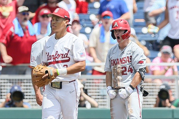 Arkansas outfielder Braydon Webb (24) reacts as slides to third, Saturday, June 18, 2022 during the first inning of the NCAA College World Series at Charles Schwab Field in Omaha, Neb.
