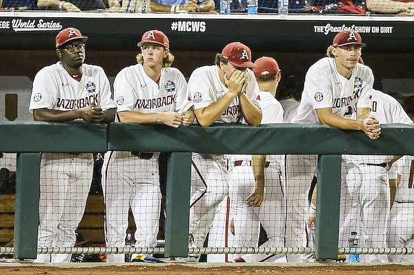 Arkansas players watch from the dugout during a 13-5 loss to Ole Miss at the College World Series on Monday, June 20, 2022, in Omaha, Neb. Arkansas players watch from the dugout during a 13-5 loss to Ole Miss at the College World Series on Monday, June 20, 2022, in Omaha, Neb.