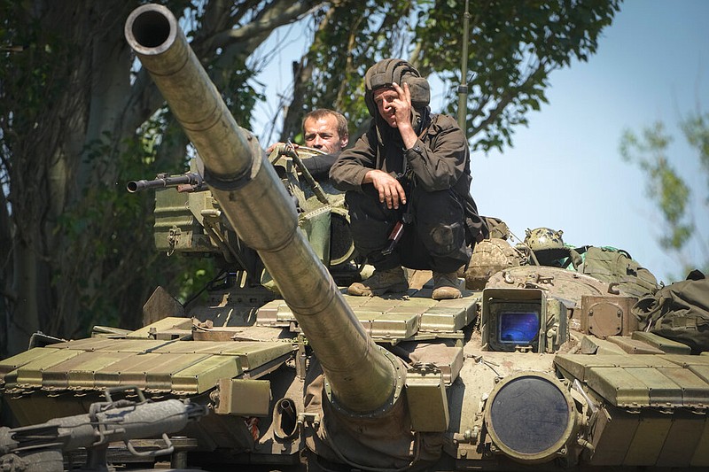 A Ukrainian soldier flashes the victory sign atop a tank in Donetsk region, Ukraine, Monday, June 20, 2022. (AP Photo/Efrem Lukatsky)