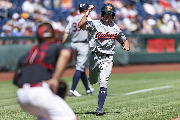 Auburn Blake Rambusch scores a run in the seventh inning against Stanford during an NCAA College World Series baseball game, Monday, June 20, 2022, in Omaha, Neb. (AP Photo/John Peterson)