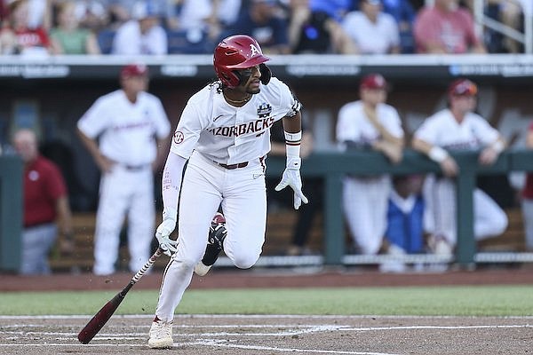 Arkansas shortstop Jalen Battles runs toward first base during a College World Series game against Ole Miss on Monday, June 20, 2022, in Omaha, Neb.