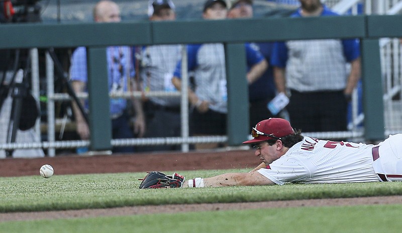 Arkansas Cayden Wallace (7) fields the ball, Monday, June 20, 2022 during the third inning of a NCAA College World Series double elimination game at Charles Schwab Field in Omaha, Neb. Visit nwaonline.com/220621Daily/ for today's photo gallery...(NWA Democrat-Gazette/Charlie Kaijo)