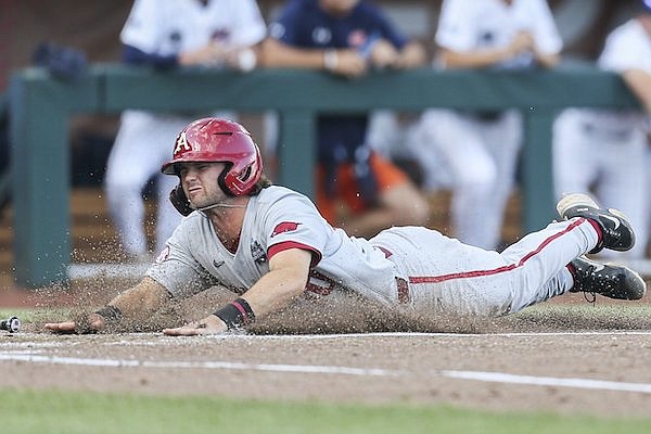 Arkansas first baseman Peyton Stovall scores a run during a College World Series game against Auburn on Tuesday, June 21, 2022, in Omaha, Neb.