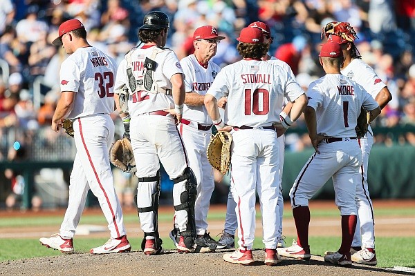 Arkansas head coach Dave Van Horn relieves pitcher Zack Morris (32), Monday, June 20, 2022 during the first inning of a NCAA College World Series double elimination game at Charles Schwab Field in Omaha, Neb. Visit nwaonline.com/220621Daily/ for the photo gallery.
