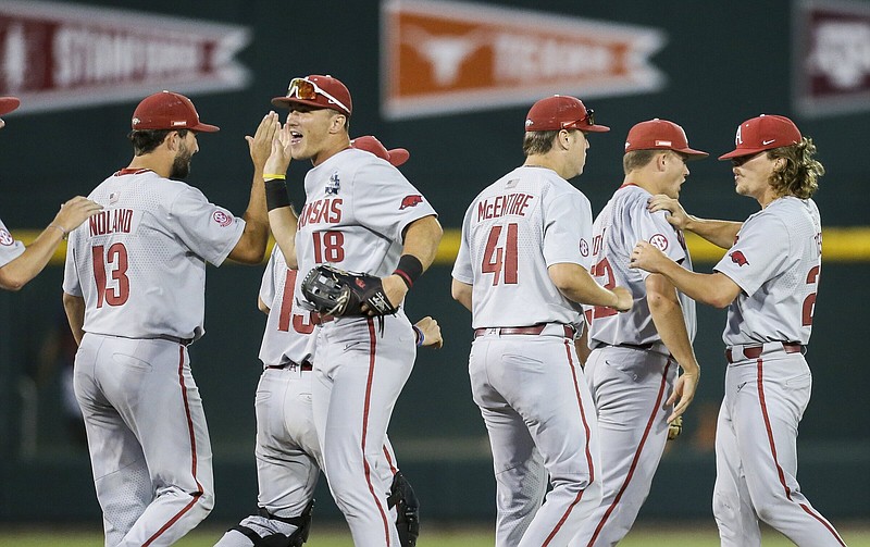 Arkansas players celebrate after the Razorbacks’ victory over Ole Miss on Wednesday night at the College World Series in Omaha, Neb. The teams meet again today with the winner advancing to the best-of-3 championship series against Oklahoma. More photos available at arkansasonline.com/623cws.
(NWA Democrat-Gazette/Charlie Kaijo)