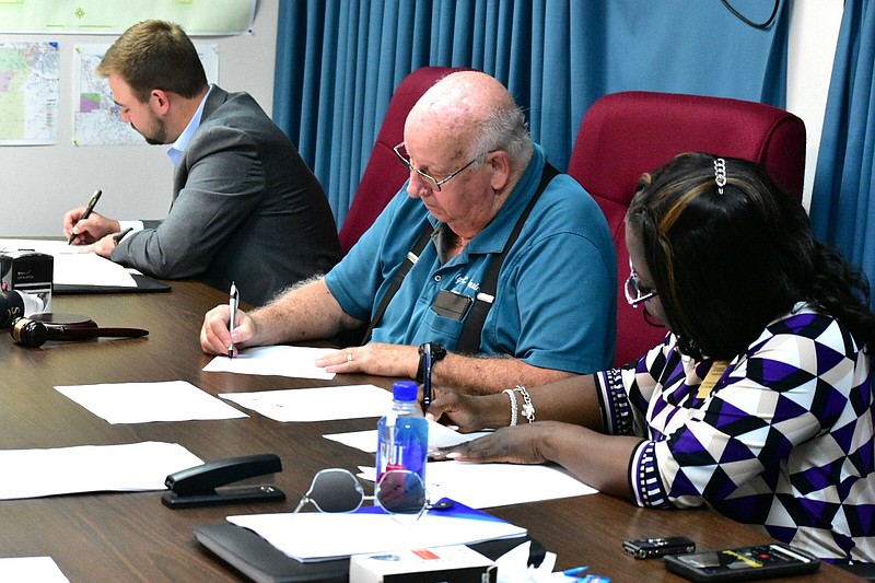 Jefferson County Election Commissioners Samuel Beavers (left), Michael Adam and Sharon Hardin judge provisional ballots during a special called meeting Wednesday. Adam, the commission chairman, said results won’t be made official until June 30. 
(Pine Bluff Commercial/I.C. Murrell)