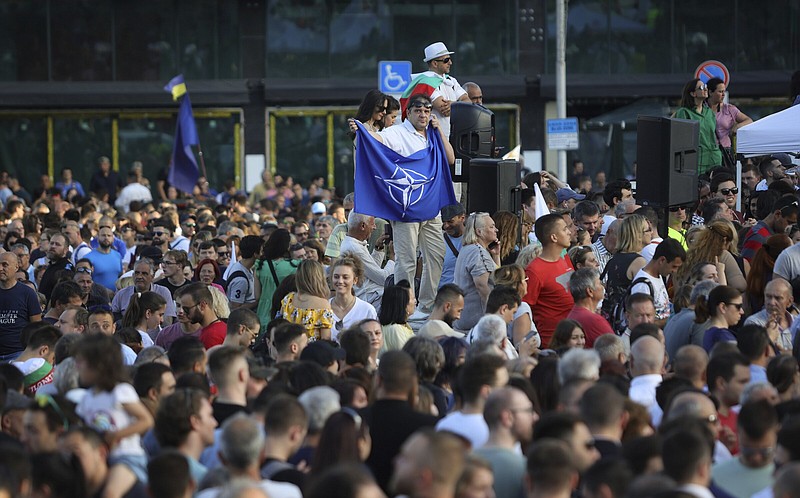 A demonstrator holds a NATO flag during a rally Wednesday in support of the incumbent government in front of the Parliament building in Sofia, Bulgaria.
(AP/Valentina Petrova)