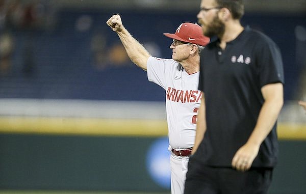 Arkansas coach Dave Van Horn (21) celebrates following an 11-1 College World Series victory over Auburn on Tuesday, June 21, 2022, in Omaha, Neb.