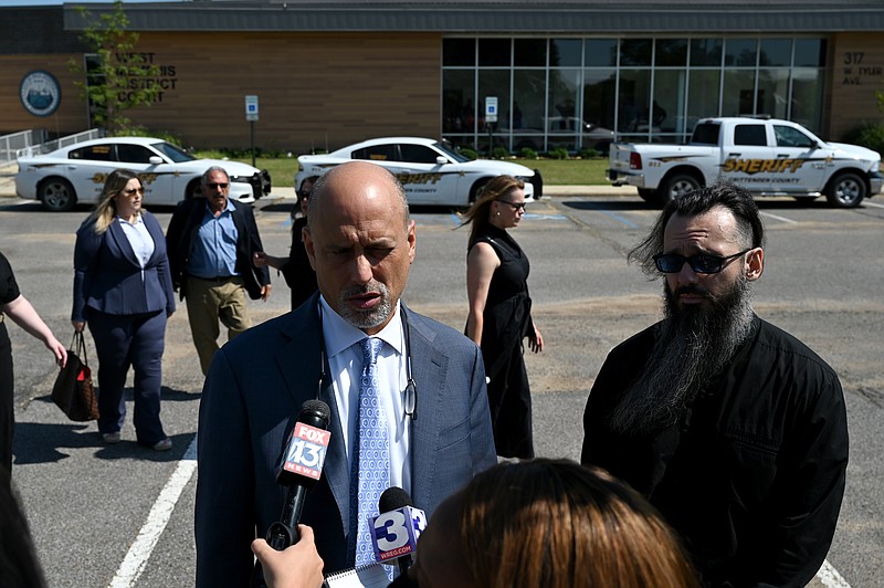 Damien Echols, right, stands with his lawyer, Patrick Benca, as they answer questions from the media following a hearing at the West Memphis District Courthouse on Thursday, June 23, 2022. See more photos at arkansasonline.com/624wm3/..(Arkansas Democrat-Gazette/Stephen Swofford)