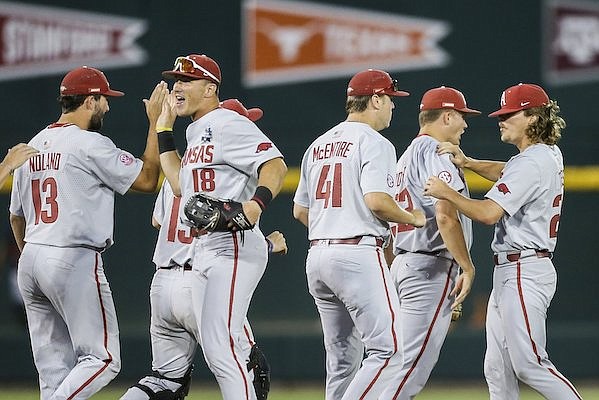 Arkansas players celebrate following a 3-2 victory over Ole Miss at the College World Series on Wednesday, June 22, 2022, in Omaha, Neb.