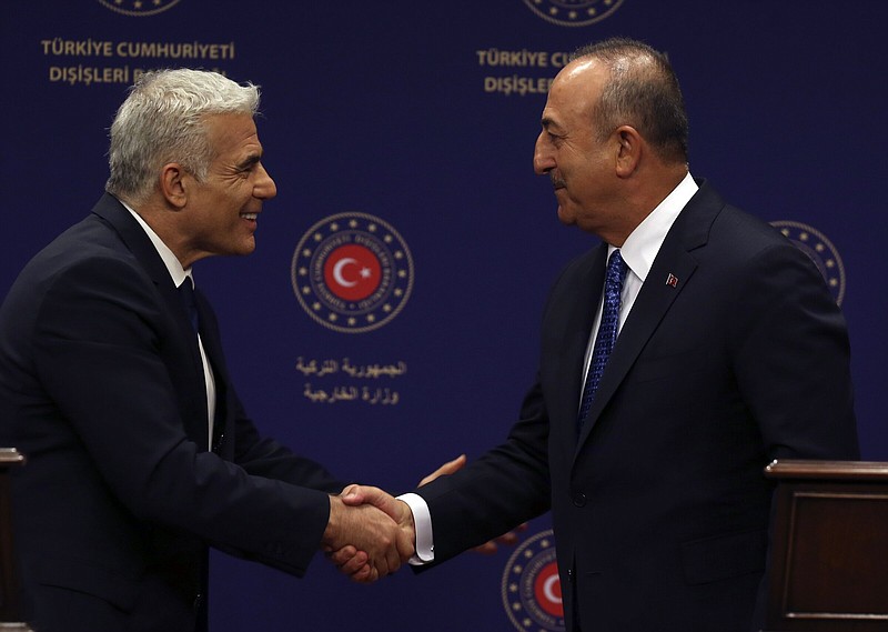 Turkish Foreign Minister Mevlut Cavusoglu (right) and Israeli Foreign Minister Yair Lapid shake hands after statements Thursday in Ankara, Turkey.
(AP/Burhan Ozbilici)