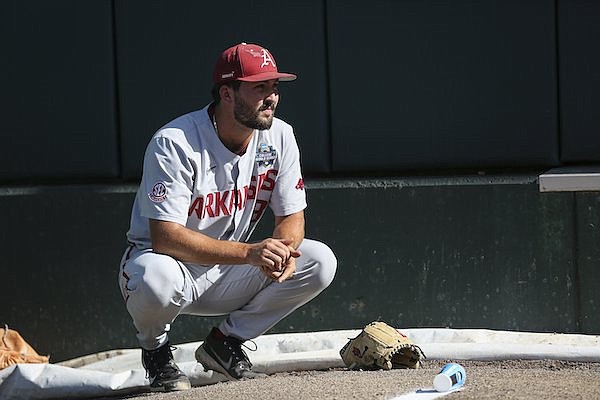 Arkansas pitcher Connor Noland watches during warmups prior to a College World Series game against Ole Miss on Wednesday, June 22, 2022, in Omaha, Neb.