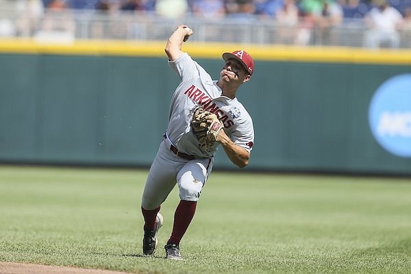 Arkansas second baseman Robert Moore throws during a College World Series game against Ole Miss on Thursday, June 23, 2022, in Omaha, Neb.