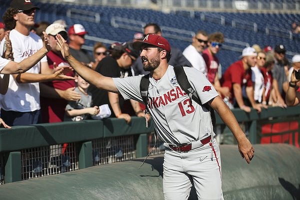 Arkansas pitcher Connor Noland walks off the field following a 2-0 loss to Ole Miss at the College World Series on Thursday, June 23, 2022, in Omaha, Neb.