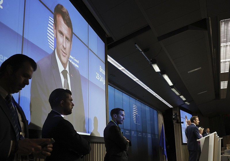 French President Emmanuel Macron, (on podium, from left) European Council President Charles Michel and European Commission President Ursula von der Leyen participate in a news conference at a European Union summit in Brussels on Friday.
(AP/Olivier Matthys)